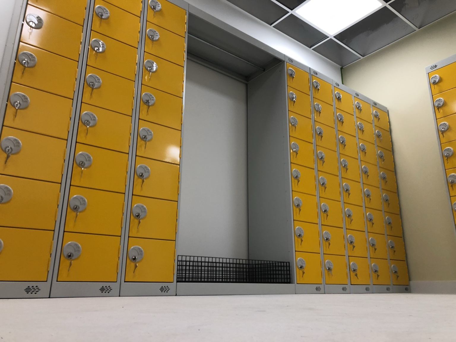 Banks of yellow and grey key-operated lockers installed by CWS